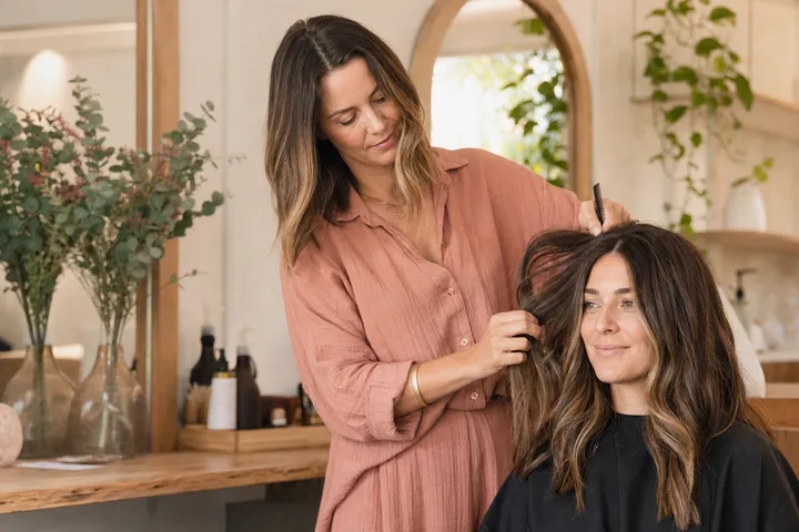 Independent salon owner styling a client's hair